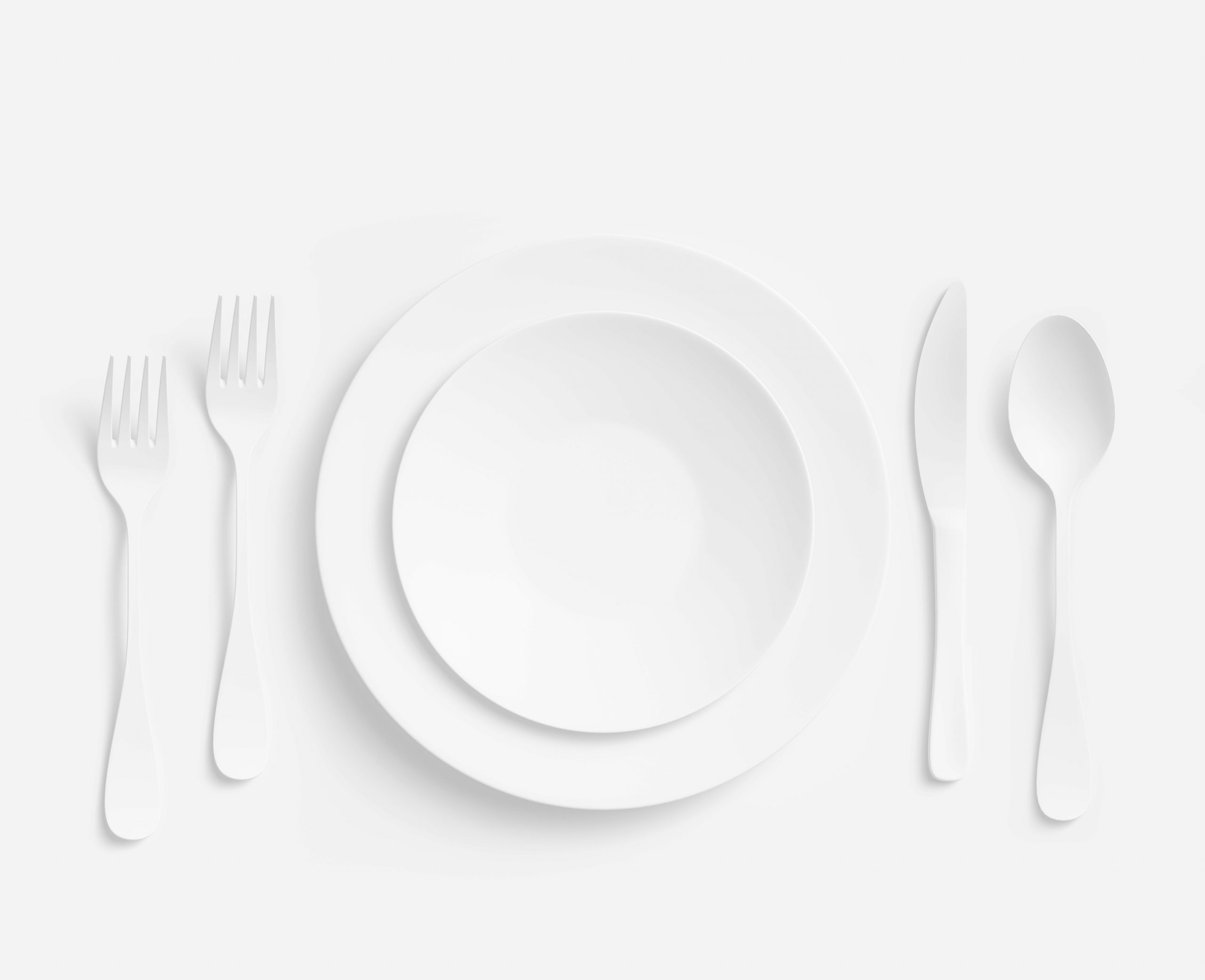 White table setting with fork, knife, spoon and plate